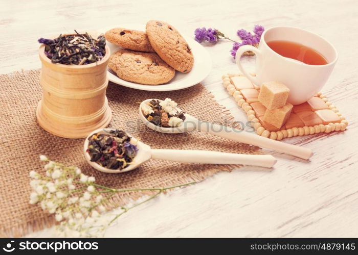 Herbal tea and cookies. Various kinds of herbal tea on wooden table