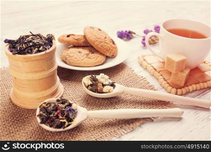 Herbal tea and cookies. Various kinds of herbal tea on wooden table