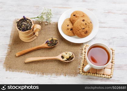 Herbal tea and cookies. Various kinds of herbal tea on wooden table