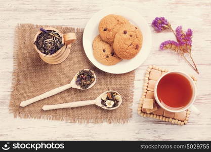 Herbal tea and cookies. Various kinds of herbal tea on wooden table