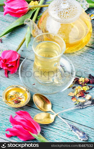 Herbal tea and spring tulip. Cup with fragrant tea and spring pink tulips