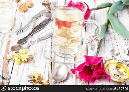 Herbal tea and spring tulip. Cup with fragrant tea and spring pink tulips