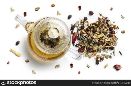 Herbal tea and teapot on white background. The view from the top.. Herbal tea and teapot on white background. The view from the top