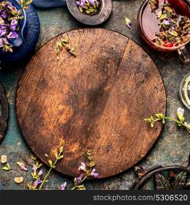 Herbal tea background with cup of tea and healing plants and flowers, top view