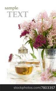 herbal tea, candles and fresh wild flowers on white background with sample text