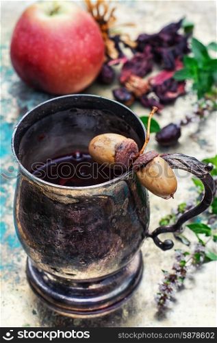 Herbal tea . Herbal tea in iron stylish mug for medicinal herbs with fruit