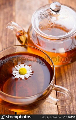 Herbal tea in glass mug and teapot