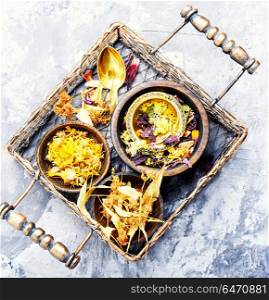 Herbal tea leaves. Herbal floral tea with mortar in a stylish basket