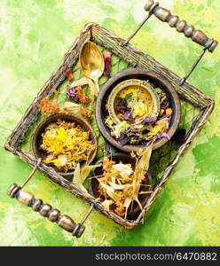 Herbal tea leaves. Herbal floral tea with mortar in a stylish basket