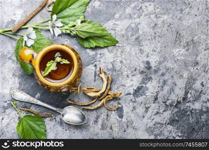 Herbal tea.Medicinal tea with althaea herbs.Medicinal herbs.Healthy decoction. Althaea Herbal Tea