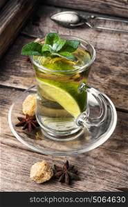 Herbal tea.Tea with mint and lemon. tea brewed with lime and mint on wooden background