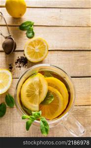 Herbal tea with lemon and mint on a wooden background. Delicious drink for relaxation and alternative therapy of diseases.. Herbal tea with lemon and mint on wooden background. Delicious drink for relaxation and alternative therapy of diseases.