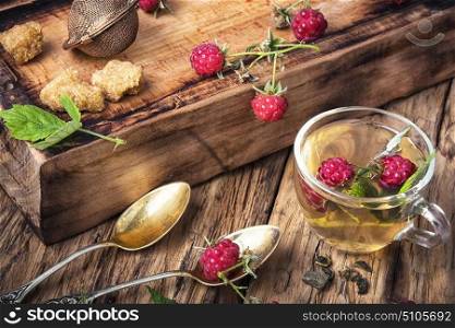 Herbal tea with raspberries. Herbal medicinal tea with ripe fresh raspberry berries