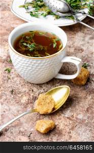 Herbal tea with thyme. Cup of herbal tea brewed from the sprigs of fresh thyme