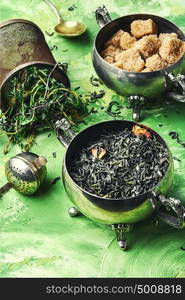 herbal tea with thyme. Dry tea leaves and sugar with cane sugar