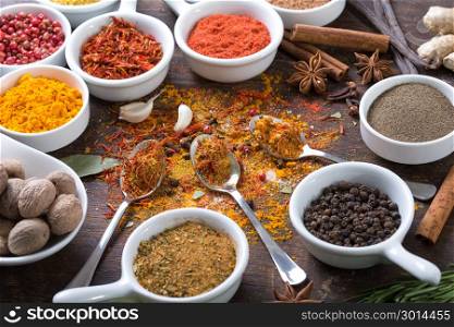 Herbs and spices in ceramic bowls. Aromatic ingredients and natural food additives.
