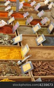 Herbs and spices in wooden boxes at a Provencal market in France