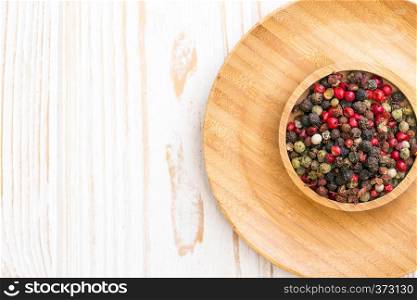 herbs and spices. mix of peppers in wooden plates on a wooden background