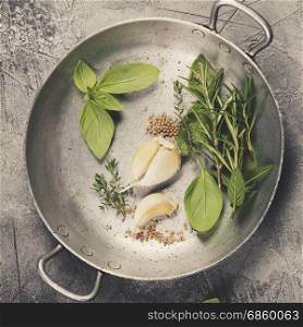 Herbs and spices on concrete background - top view, copyspace - healthy eating or cooking concept
