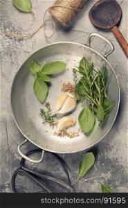 Herbs and spices on concrete background - top view, copyspace - healthy eating or cooking concept