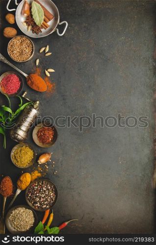 Herbs and spices on dark background - turkish, indian, asian cooking concept, flat lay, space for text