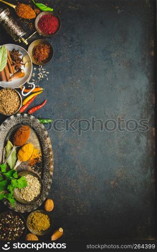 Herbs and spices on dark background - turkish, indian, asian cooking concept, flat lay, space for text. Herbs and spices on dark background