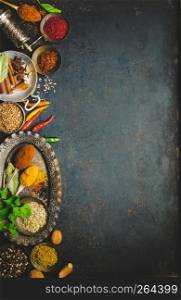 Herbs and spices on dark background - turkish, indian, asian cooking concept, flat lay, space for text. Herbs and spices on dark background