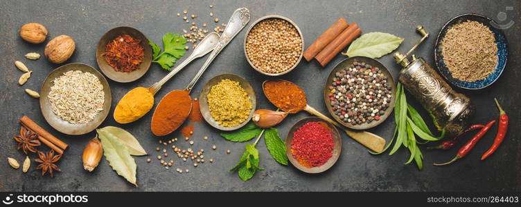 Herbs and spices on dark background - turkish, indian, asian cooking concept, flat lay, space for text. Herbs and spices on dark background, flat lay