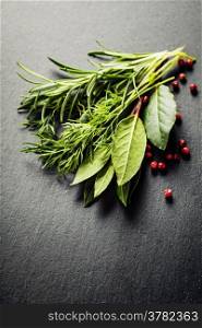 Herbs and spices on slate background - cooking, healthy or vegetarian food concept