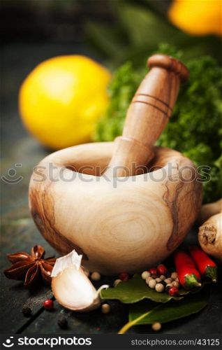 Herbs and spices with Mortar and Pestle on wooden background