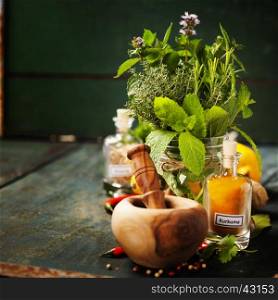 Herbs and spices with Mortar and Pestle on wooden background