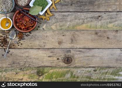 Herbs and Spices with space for text on rustic tabletop.