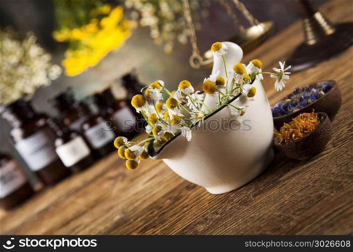 Herbs, berries and flowers with mortar, on wooden table backgrou. Natural medicine, herbs, mortar on wooden table background