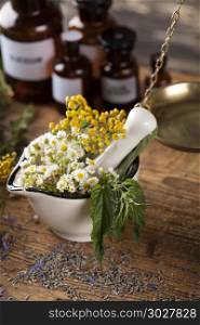 Herbs, berries and flowers with mortar, on wooden table backgrou. Herbs medicine,Natural remedy and mortar on vintage wooden desk background