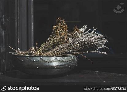 Herbs cumin and cilantro in a metal bowl. Sunlight