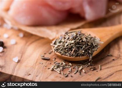 Herbs de Provence. Mixed dried herbs in spoon over wooden background, selective focus