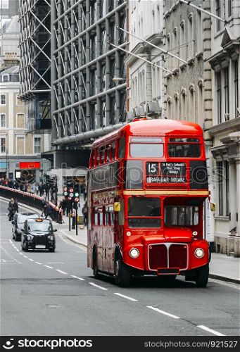 Heritage Routemaster Bus operating in a busy Central London street with traditional black cab on background.. Heritage Routemaster Bus operating in a busy Central London street with traditional black cab on background