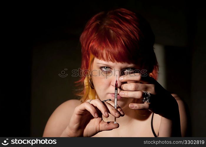 Heroin addict flicking needle