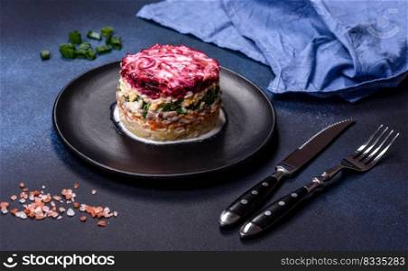 Herring salad under a fur coat. Traditional Ukrainian multilayered salad from herring, beets, potatoes, carrots and eggs. Traditional Ukrainian multilayered salad from herring, beets, potatoes, carrots and eggs