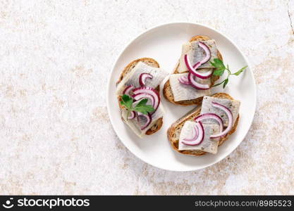 Herring sandwich. Toast with bread, herring and onion. Top view