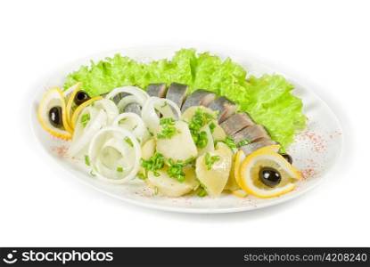Herring with potato and vegetables isolated on a white background