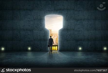 Hesitant businessman stand on wall with digital usb key hole door ,sunrise scene city skyline outdoor view .