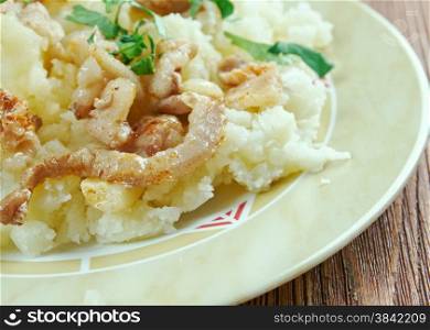 Hete bliksem stamppot - traditional German dish most popular in the regions of the Rhineland, Westphalia and Lower Saxony consists of fried onions, and mashed potato with apple sauce.