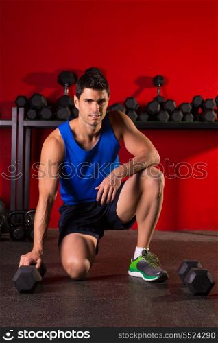 Hex dumbbells man workout in red gym floor