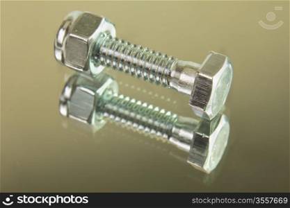 hex head bolt with lock nut on reflective surface