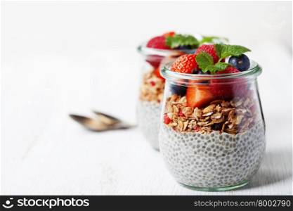 ?hia seeds vanilla pudding and berries on wooden rustic background - Healthy food, Diet, Detox, Clean Eating or Vegetarian concept. Background layout with free text space.