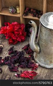 Hibiscus tea. Hibiscus tea rose and welding on the background of the tea shelves in vintage style.Photo tinted.Selective focus