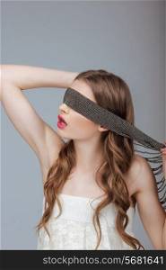 Hide and Seek. Woman Holding a Strap on her Face. Puzzle