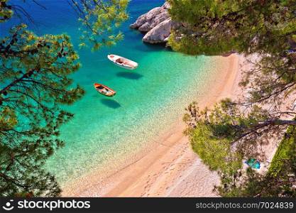 Hiden beach in Brela with boats on emerald sea aerial view, Makarska riviera of Dalmatia, Croatia