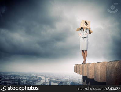 Hiding emotions. Businesswoman in suit wearing carton box on head